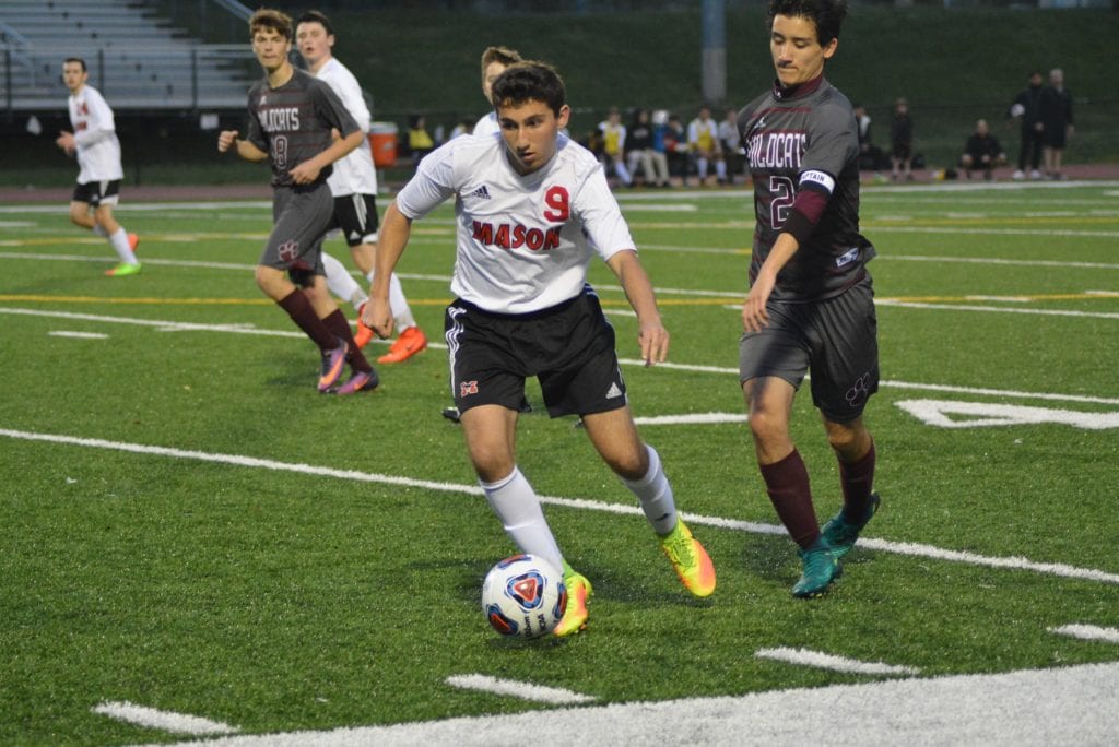 EVADING A DEFENDER is junior forward Peter Scardino. Scardino scored one of Mason's eight goals against Warren County on Tuesday night (Photo: Carol Sly)