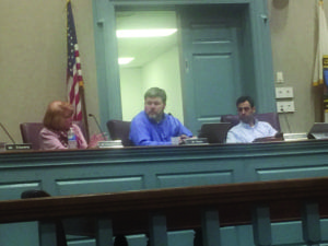 FALLS CHURCH PLANNING COMMISSION appointees to the new economic development task force for the campus project compared notes Monday night, left to right, alternate Lindy Hockenberry, Andy Rankin and Russ Wodiska. (Photo: News-Press)