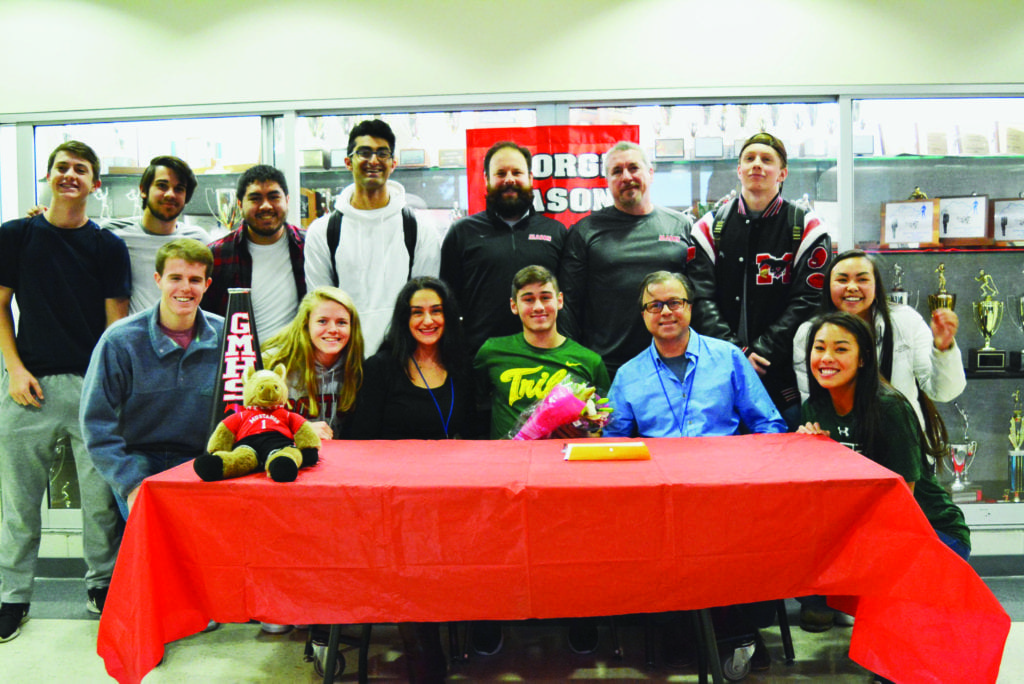 Derin Kokuuslu (center, in green) with friends and family after signing letter of intent to play soccer at the College of William and Mary (Photo: Carol Sly)