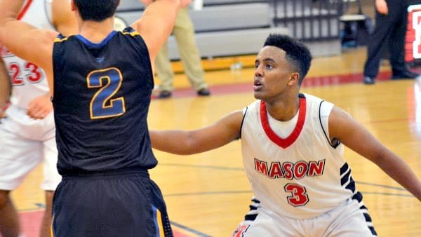 GEORGE MASON JUNIOR Biruk Teshome locks in on defense against Central on Tuesday. Teshome led the Mustangs with 20 points in the team’s 63-45 win. (Photo: Carol Sly)