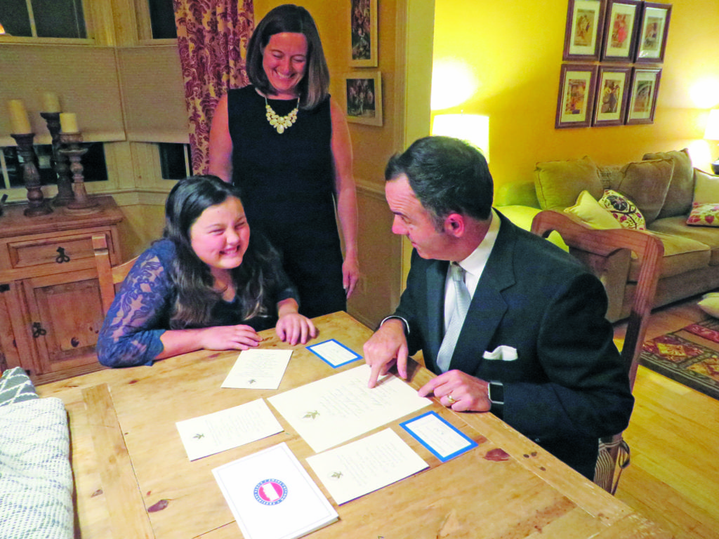 Madison, Jennifer and Matt Keelen of Falls Church review official invitations to the Donald Trump Presidential Inauguration this Friday. (Photo: News-Press)