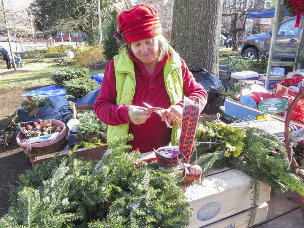 RHONDA STEVENSON assembles a wreath at the City of Falls Church’s Holiday Farmers Market, which opened on Saturday, Dec. 3. The Holiday Farmers Market’s remaining dates are December 10 and 17. (Photo: Patricia Leslie/News-Press)