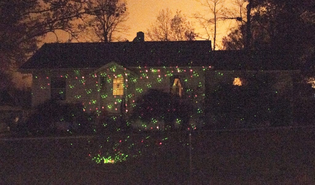 THE STAR SHOWER LASER LIGHT, seen being used on the Northern Virginia home above, has been a popular alternative to string lights. (Photo: Drew Costley/News-Press)