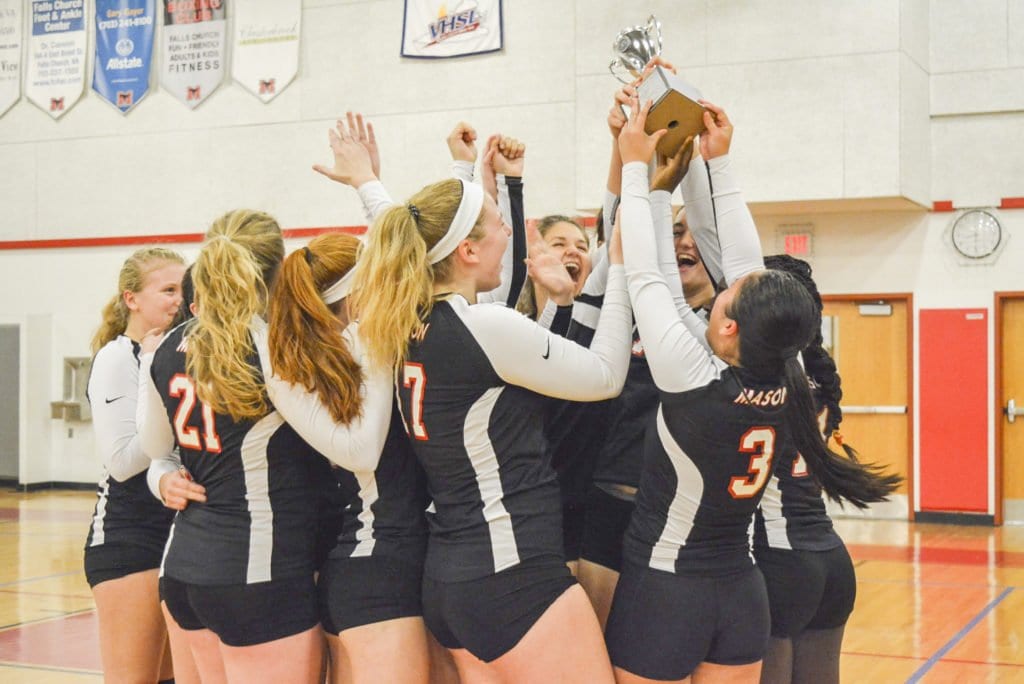 MASON’S VOLLEYBALL TEAM hoists the Conference 35 trophy after winning the championship game against Clarke County High School on Thursday, Nov. 3. The Mustangs lost in the regional tournament to Robert E. Lee High School. Hillary Trebels, the Mustangs’ head coach, said the 2016-2017 season was one the program’s most successful. (Photo: Carol Sly)