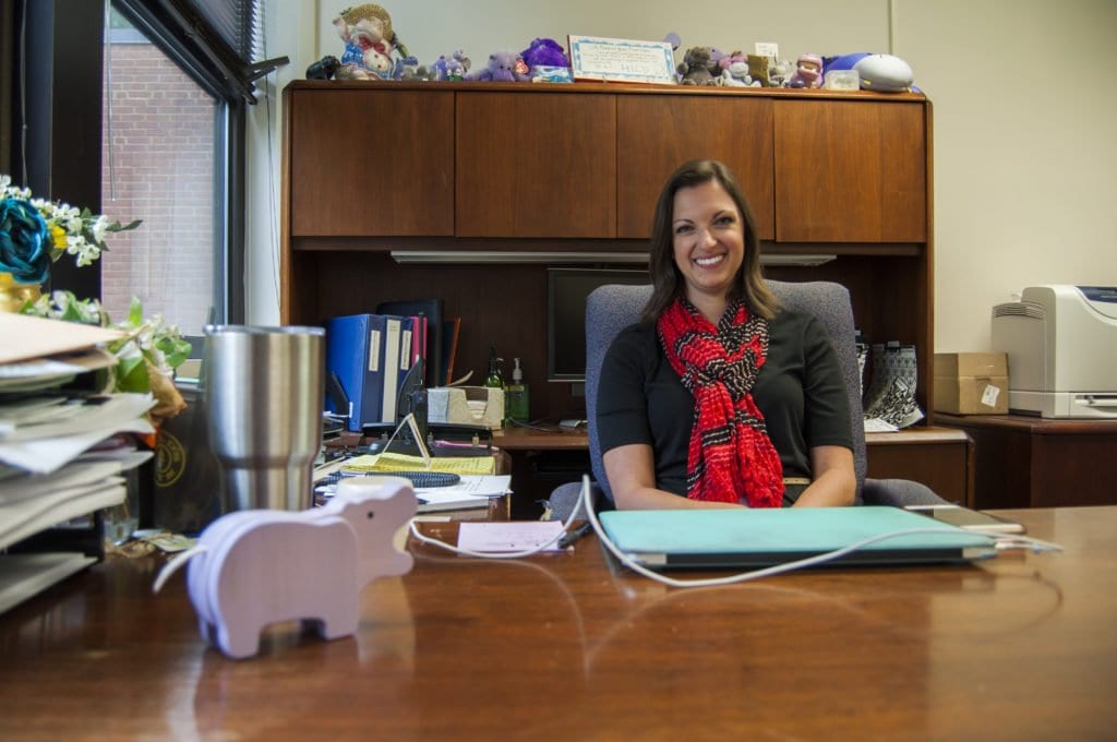 NEW MT. DANIEL SCHOOL PRINCIPAL Erin Kelly sits at the desk that was occupied by her predecessor, Kathy Halayko, for nearly two decades. Kelly said that Halayko left behind her collection of purple hippopotami, some of which were left behind by Halayko’s predecessor. (Photo: Drew Costley/News-Press)