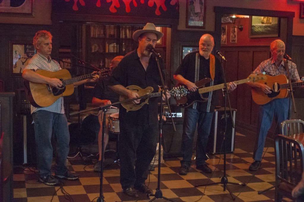 ROOTS MUSICIAN ANDREW ACOSTA (center) performed at Famous Dave’s on Tuesday, Sept. 13 and will be be part of the concert to end gun violence on Saturday, Sept. 24. (Photo: Drew Costley/News-Press)