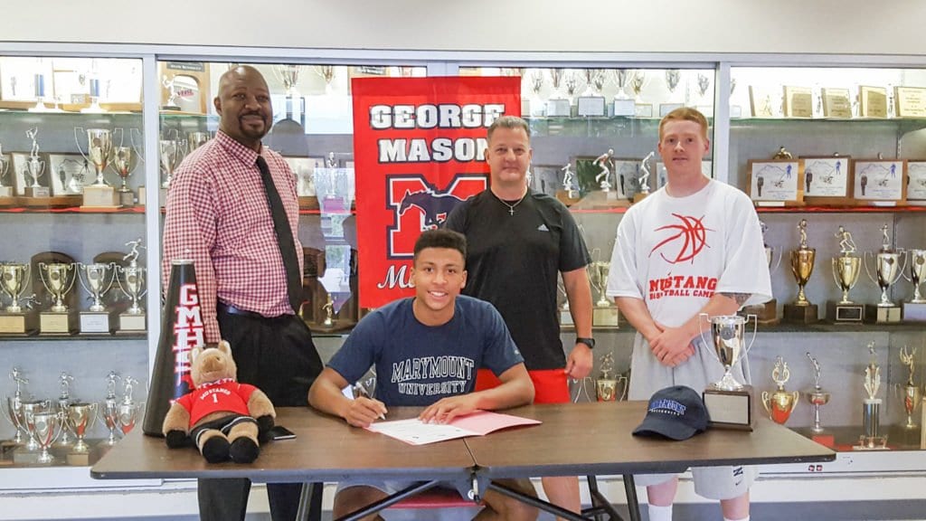 MASON GRADUATE ROBERT TARTT (sitting down) signed a letter of intent for Marymount University on Monday, June 27. (Photo: Courtesy of Julie Bravin)