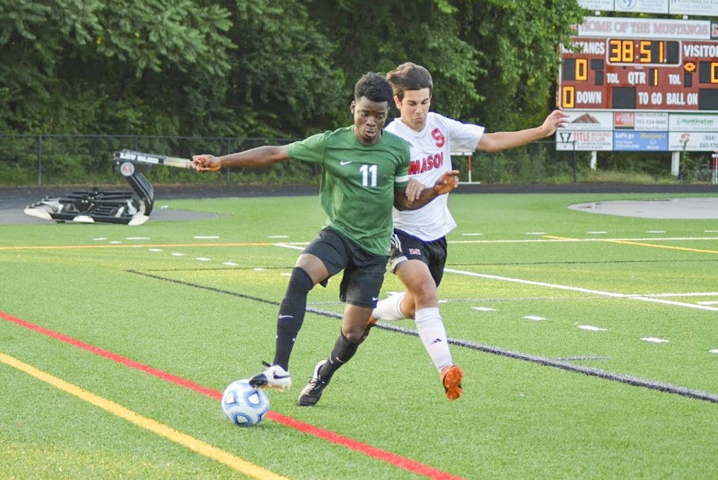 Junior midfielder Olo Sembera takes on a Bruton player during the Mustangs 3-0 victory over the team. Sembera set up the Mustangs' first goal of the game with a corner kick to senior forward Elliot Mercado. (Photo: Carol Sly)