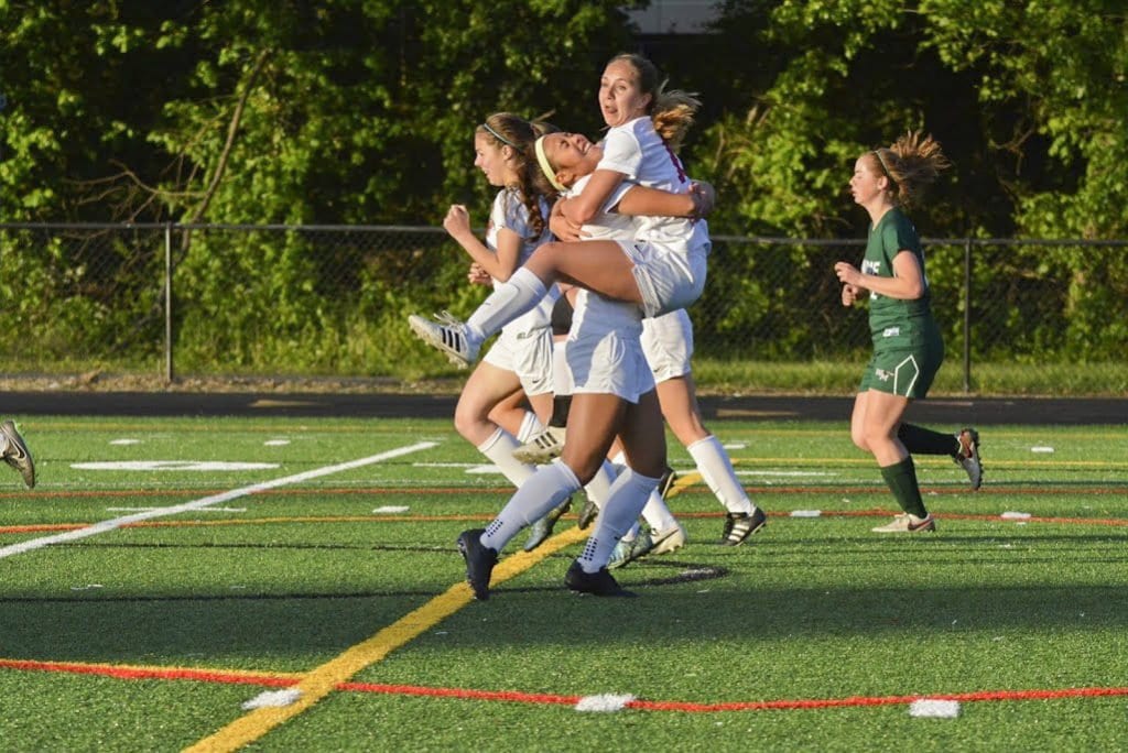 Mason senior Corrine Carson (right) jumps into the arms of Mason junior Rebecca Crouch (left) after her goal against William Monroe High School, which the Mustangs won 4-1. Crouch also scored a goal in the match. (Photo: Carol Sly)