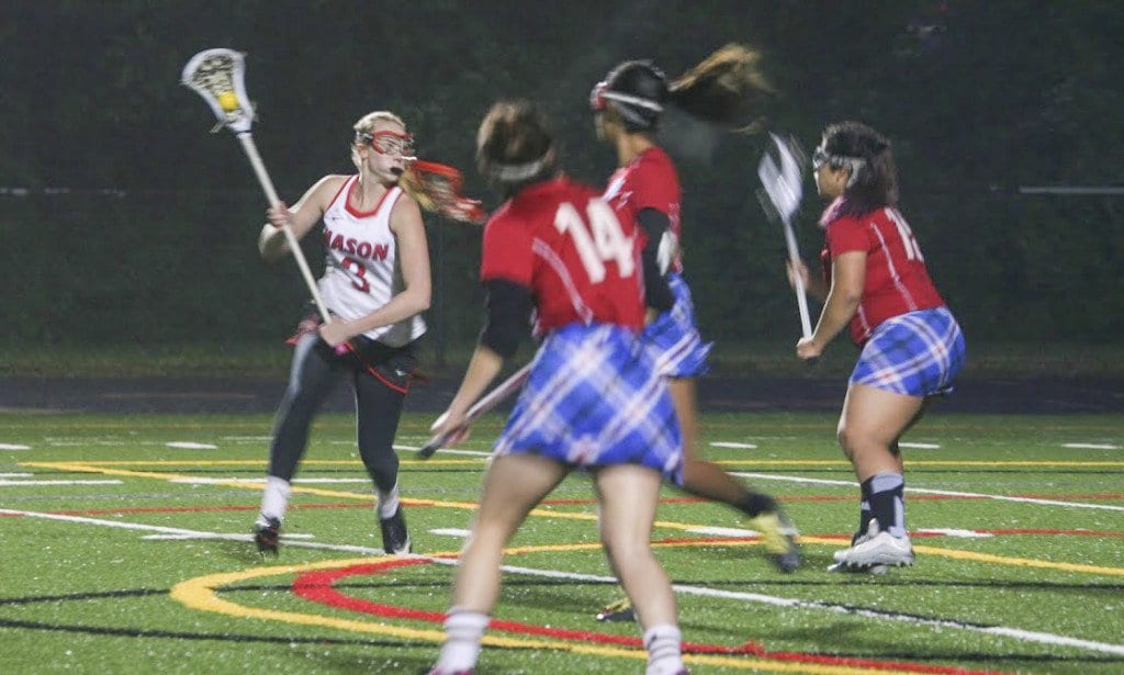 MASON SOPHOMORE CLAIRE TRUNDLE craddles the ball during the Mustangs’ win over Park View High School. (Photo: FCCPS Photo/Jen Cipriano)