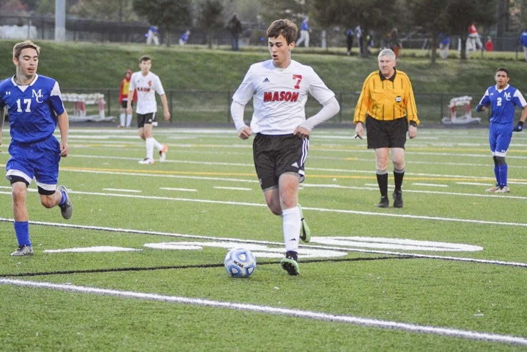 MASON SENIOR ELLIOT MERCADO dribbles the ball down the field during a recent Mustangs’ win over Madison County High School. Mercado scored a hat trick against the Mustangs’ most recent opponent, Strasburg High School, during the team’s 5-0 win over the Rams on Friday, April 29. (Photo: Carol Sly)