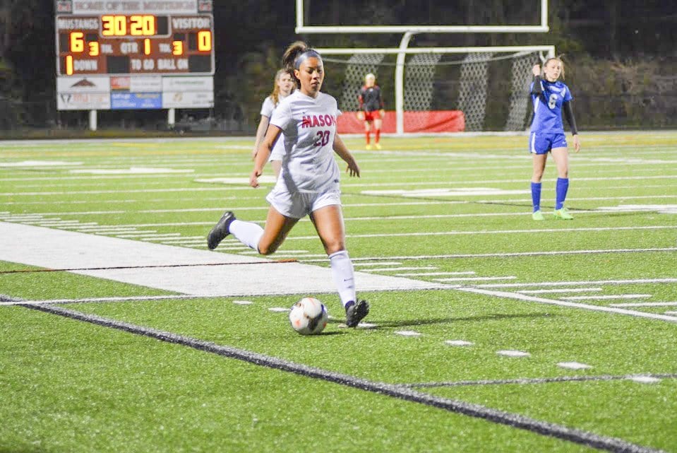 REBECCA CROUCH, junior midfielder on Mason’s girls soccer team, prepares to kick the ball during a recent Mason win. She scored the Mustangs’ last goal against Warren County High School during their 5-0 win over the Wildcats on Tuesday, April 26. (Photo: Carol Sly)