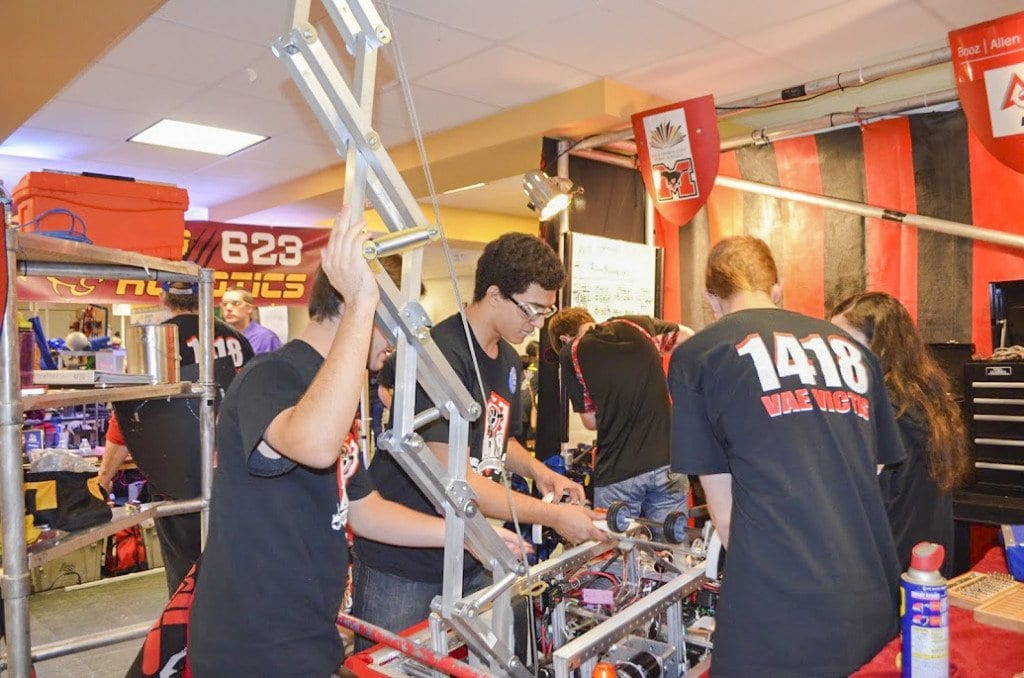 Team 1418’s pit crew works on a robot in between games during a recent compeition. The team is headed to Worlds, which takes place April 27-30. (Photo: Carol Sly)