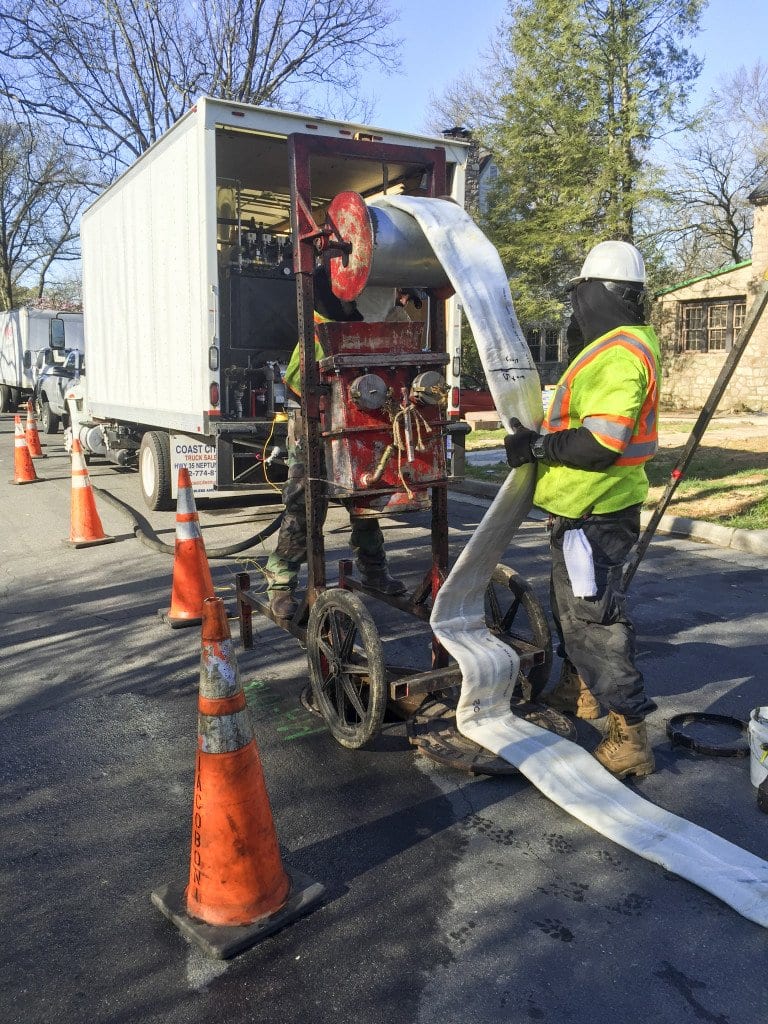 A CITY EMPLOYEE UNLOADS fiberglass lining to rehabilitate the sanitary sewer system on Linden Lane on Wednesday, March 30. (Photo: Courtesy of Lonnie Marquetti)