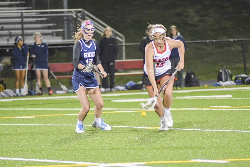 Mason sophomore Claire Hiscott scoops up a ground ball during the Mustangs’ 21-3 trampling of Washington-Lee High School on Monday, March 28. Hiscott scored a hat trick against the generals and had the assist on another goal. (Photo: Carol Sly)