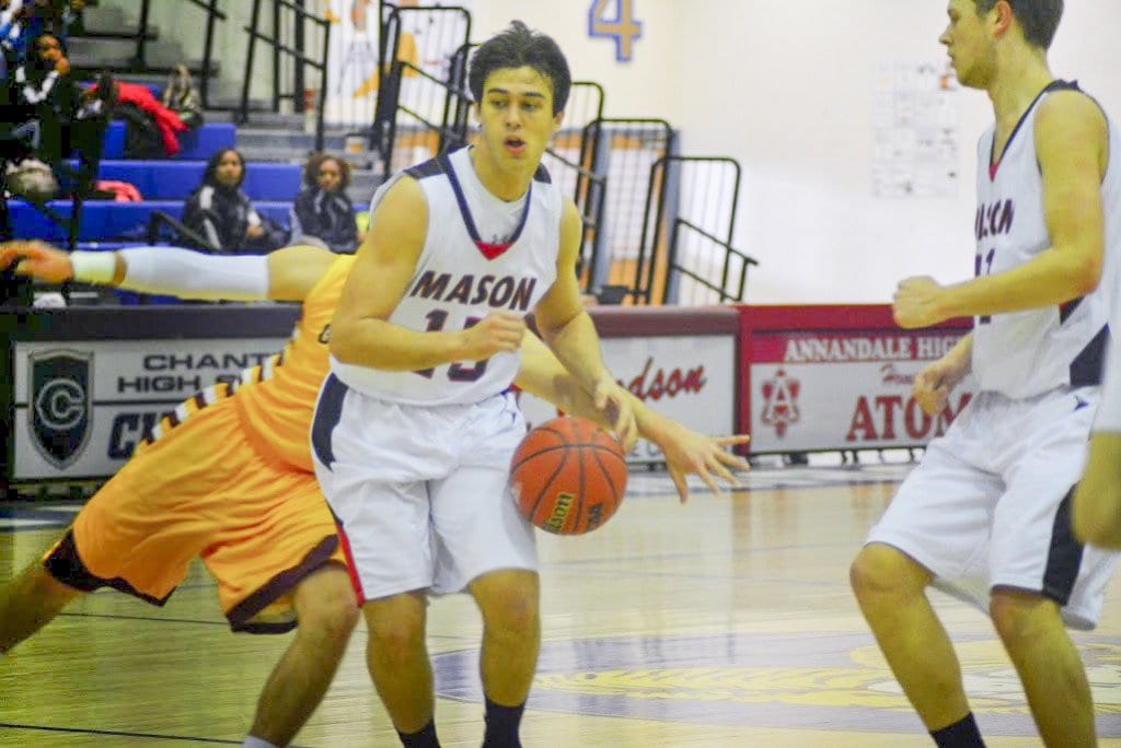 MASON SENIOR ELIOTT MERCADO sank the two free throws that sent the Mustangs into overtime against Greensville County. He's shown here driving down the court against Graham High School in the opening round of the state championship. (Photo: Carol Sly)