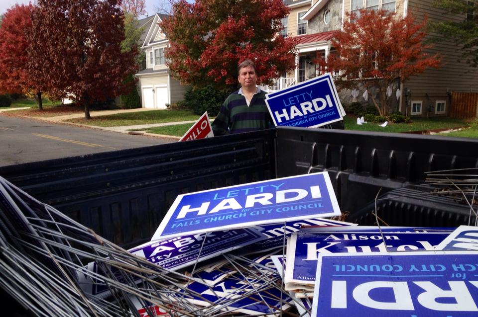 TOM CLINTON GETS READY to throw some of the 2015 candidates’ campaign signs into the back of his pickup truck. Clinton and City councilmember Phil Duncan have been picking up campaign signs after Election Day since 2000. (Courtesy Photo)