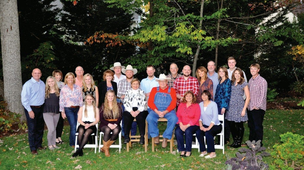 Bob warhurst (center, wearing a hat and red shirt) with his family. Multiple generations of his family have worked at the Merrifield Garden Centers, which he co-founded in 1971. Warhust passed away late last month. (Courtesy Photo)