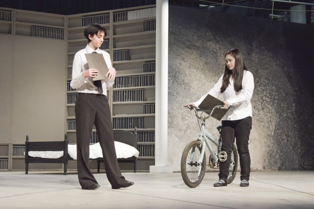 Lead character Jonas, played by Bailey Singer, talks to his little sister Lily, played by Danielle Phan, after being selected as the Receiver of Memories in a rehearsal for Falls Church High School’s production of “The Giver.” (Photo: Liz Lizama/News Press)