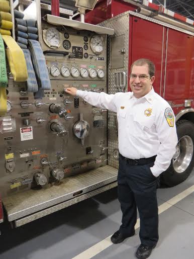 Ian Weston, the president of the Falls Church Volunteer Fire Department, describes the parts of a fire engine at the fire hall at 6950 Little Falls Road in Arlington. (Photo: Patricia Leslie/News-Press)