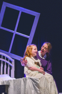 Susan Derry as Miss Giddens sings with Libby Brooke, who plays Flora Bly.The play, a musical adaptation of Henry James’ novella by the same name, tells the story a young governess who believes that her two young students are being manipuated by evil forces. (Photo: Courtesy of Keith Waters/Kx Photography)