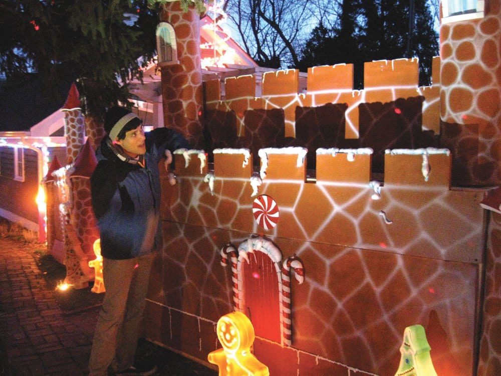 JACK LANOUETTE PUTS SOME finishing touches on the decorations at his home’s Christmas display on East Broad Street. (Photo: News-Press)