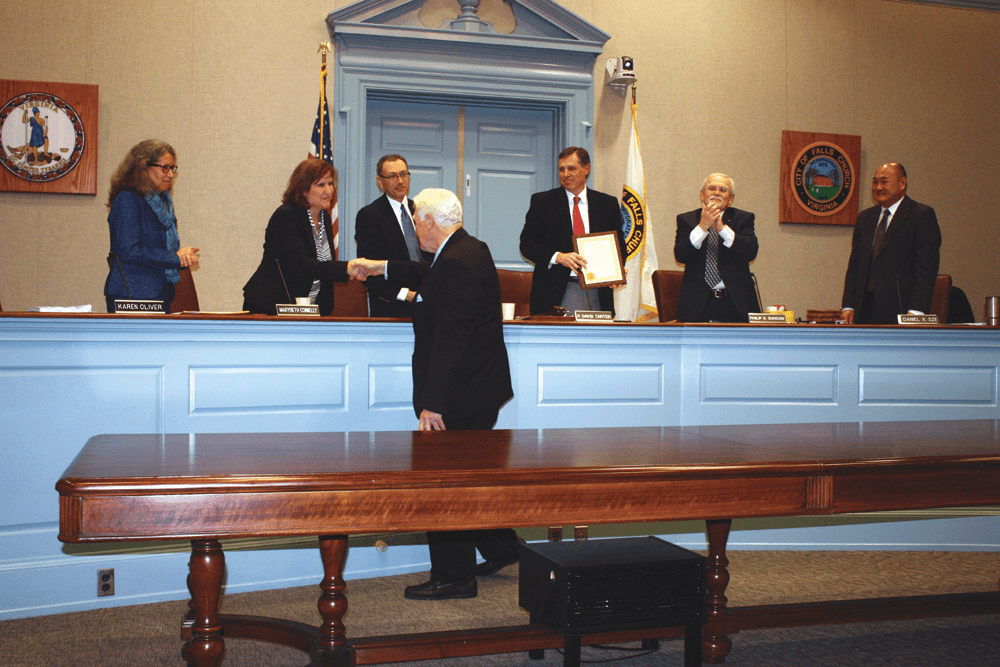 BEING HONORED FOR HIS 24 years of service as a U.S. Congressman representing the 8th District of Virginia, including the City of Falls Church, retiring U.S. Rep. Jim Moran was presented with a unanimously-voted resolution of commendation at Monday’s Falls Church City Council meeting, and he went onto the dais to shake the hands of every Council member present. Moran leaves office in early January. (Photo: News-Press)