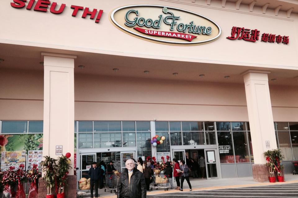 Councilman Phil Duncan poses in front of the Good Fortune supermarket which opened in the Eden Center Saturday.