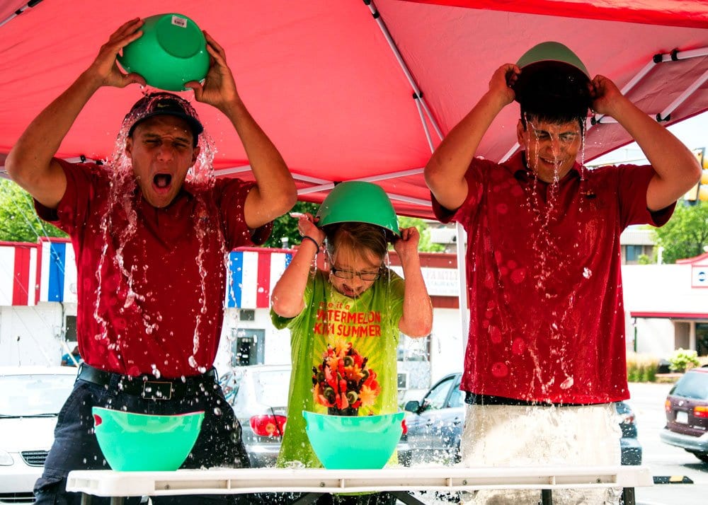 ACCEPTING THE ALS ICE BUCKET CHALLENGE, Oscar Soto, Taylor Smith and George Weiss (left to right) of Falls Church’s Edible Arrangements, dumped buckets of water on their heads at the Annandale Road store last Wednesday, August 20. In addition to completeing the challenge, the store donated $100 to an ALS organization. (Photo: News-Press)