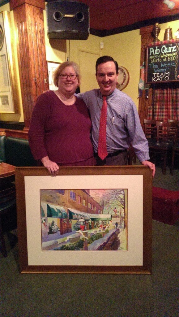 Former City of Falls Church treasurer Cathy Kaye (left) is seen above with Colm Dillon, owner of Ireland's Four Provinces restaurant, and the painting she donated to the 4P's last week.
