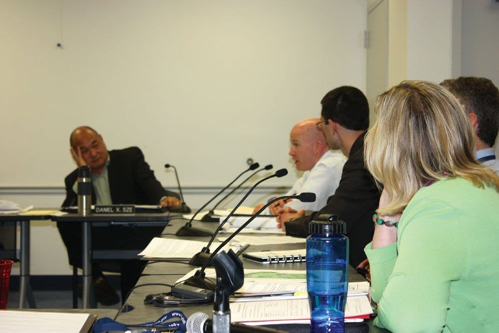 SUBJECT OF AN INTENSE discussion at Monday’s Falls Church City Council work session, Councilman Dan Sze (left) confronts the City staff on plans to delay traffic calming work at the intersection of Parker and Kent.