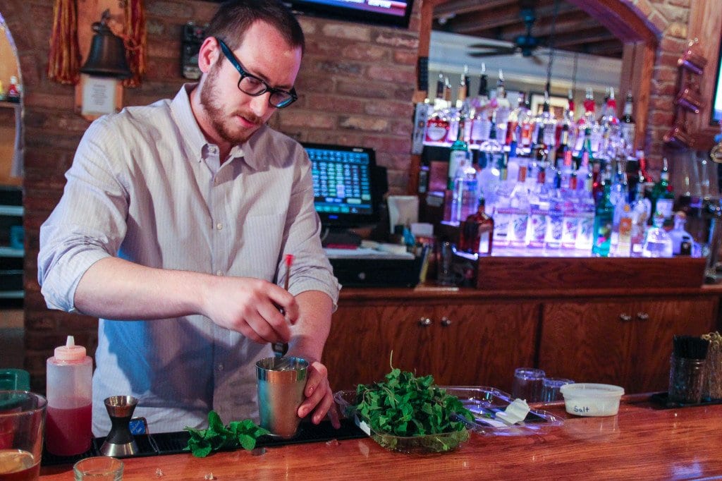 PAUL TAYLOR, the new beverage director for the restaurant group which includes Falls Church’s Dogwood Tavern, muddles up some mint for a Virginia julep. (Photo: News-Press)