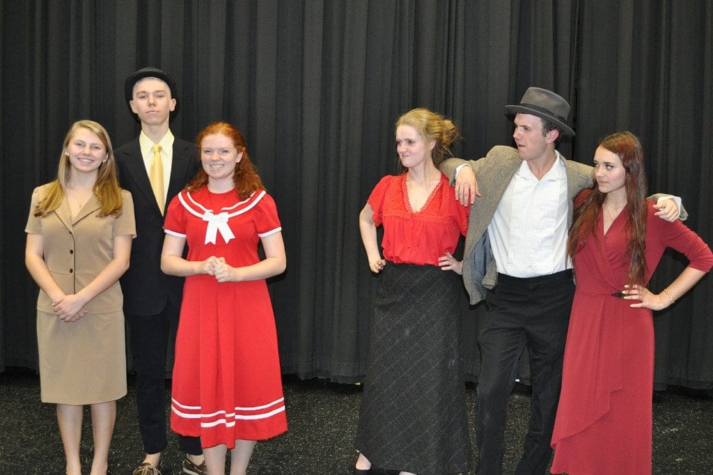 “Annie,” performed by McLean High School’s McLean Theatre Company, features lead characters, pictured from left to right, Grace Farrell (Nicole Sheehan), Daddy Warbucks (Jack Posey), Annie (Nancy Pruett), Mrs. Hannigan (Rachel Lawhead), Rooster (Thomas Kelty), and Lily St. Regis (Abby Huston). (Photo: Karen Perry)