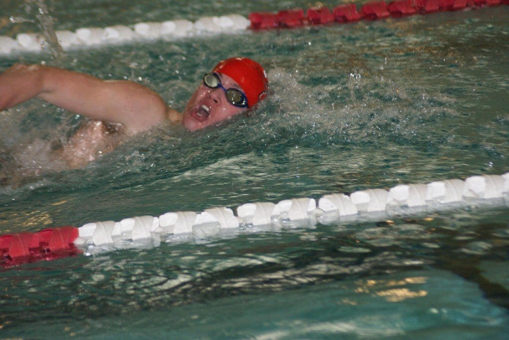 Sophomore swimmer Jared Britton races toward a state qualifying time of 50:45 in the 100-yard freestyle. (Photo: Carol Sly)